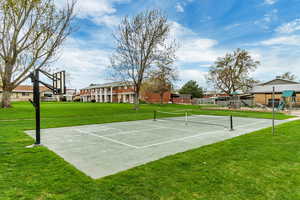 Exterior space with a yard, tennis court, and a playground