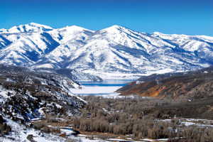 Property view of mountains featuring a water view