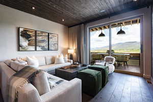 Living room featuring a mountain view, hardwood / wood-style floors, and wood ceiling