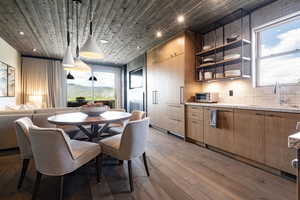 Dining room with wood-type flooring, sink, and wood ceiling