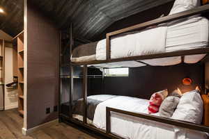 Bedroom featuring lofted ceiling and hardwood / wood-style flooring