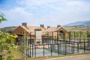 View of pool featuring a mountain view and tennis court