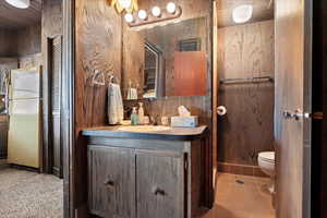 Bathroom featuring vanity, toilet, and tile patterned flooring