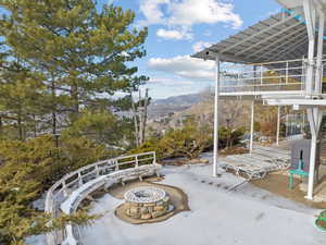 View of patio featuring a mountain view and an outdoor fire pit