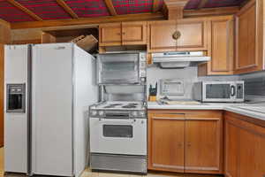 Kitchen featuring white appliances