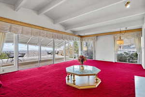 Sunroom with lofted ceiling with beams