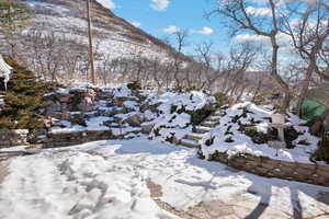 Exterior patio with waterfall outside the primary bedroom featuring a mountain view