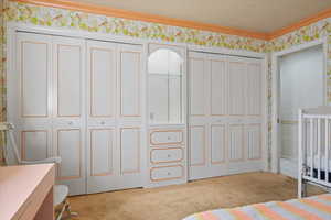 Carpeted bedroom with crown molding