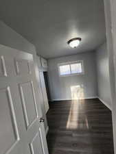 Unfurnished room featuring dark hardwood / wood-style flooring