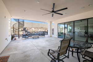 View of patio with an outdoor living space and ceiling fan