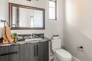 Bathroom featuring vanity and toilet