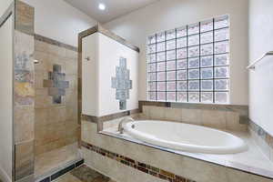 Bathroom featuring separate shower and tub