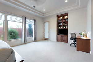 Interior space featuring ceiling fan and a tray ceiling