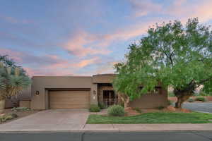 Pueblo-style house with a garage