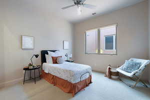 Carpeted bedroom featuring ceiling fan