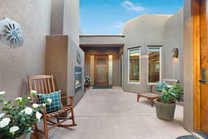 Doorway to property featuring a patio area