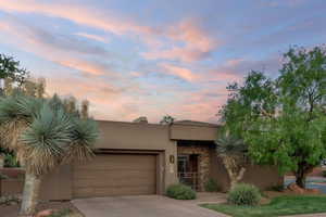 Southwest-style home featuring a garage