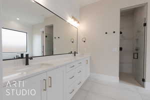 Bathroom featuring vanity, tile patterned floors, and walk in shower