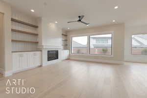 Unfurnished living room with light hardwood / wood-style flooring, a wealth of natural light, and a tile fireplace