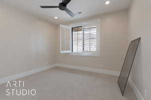 Carpeted spare room with ceiling fan