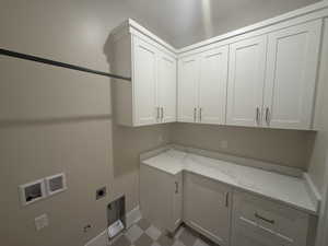 Laundry room with cabinets, gas dryer hookup, electric dryer hookup, and hookup for a washing machine