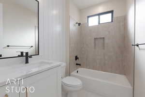 Full bathroom featuring tile patterned floors, vanity, toilet, and tiled shower / bath combo