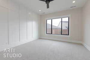 primary bedroom with light carpet and ceiling fan