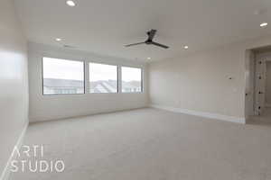 Carpeted living room featuring ceiling fan