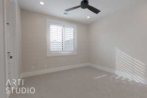 Unfurnished room featuring ceiling fan and carpet floors