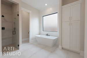 Bathroom with tile patterned flooring and independent shower and bath