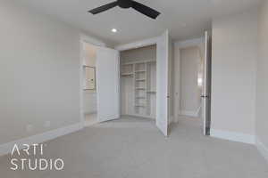 Unfurnished bedroom featuring ceiling fan, ensuite bath, a closet, and light carpet