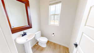 Bathroom with toilet and hardwood / wood-style floors