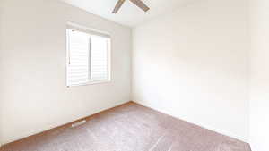 Empty room with ceiling fan and carpet