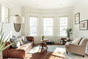 Living room with a wealth of natural light and wood-type flooring