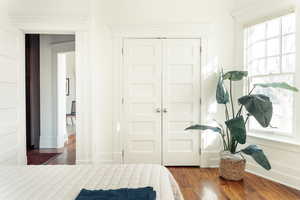 Bedroom featuring dark hardwood / wood-style floors and a closet