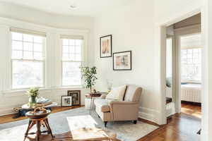 Sitting room with hardwood / wood-style flooring