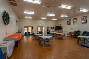 Dining room featuring a textured ceiling, wood-type flooring, and ceiling fan