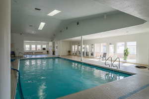 View of pool featuring a skylight