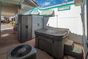 View of patio / terrace featuring a hot tub and central air condition unit