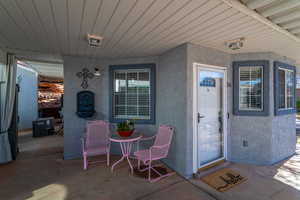 Entrance to property featuring central AC and a patio