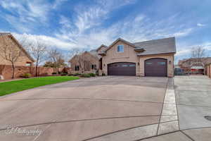 View of front of house with a garage and a front yard