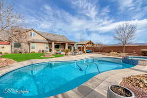 View of pool with an in ground hot tub, a gazebo, central AC unit, and a patio