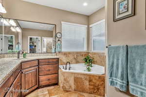 Bathroom with vanity and a relaxing tiled tub