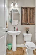 Bathroom with tile patterned flooring, sink, and toilet