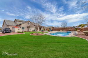 View of swimming pool featuring a yard