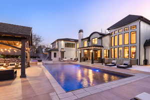 Pool at dusk featuring an outdoor hangout area and a patio area