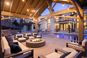 Patio terrace at dusk with an outdoor structure and an outdoor living space with a fire pit