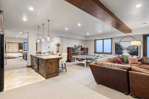 Living room featuring light carpet and beamed ceiling