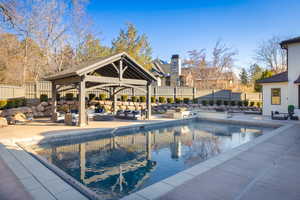View of pool with a gazebo and a patio area