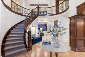 Entryway with a high ceiling and light parquet floors